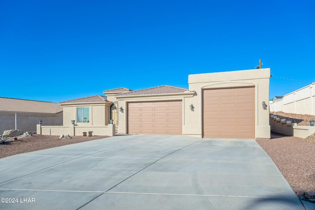 2555 Avalon Ln, Lake Havasu City, AZ 86404 - view of front facade with driveway, stucco siding, a garage, and a tile roof