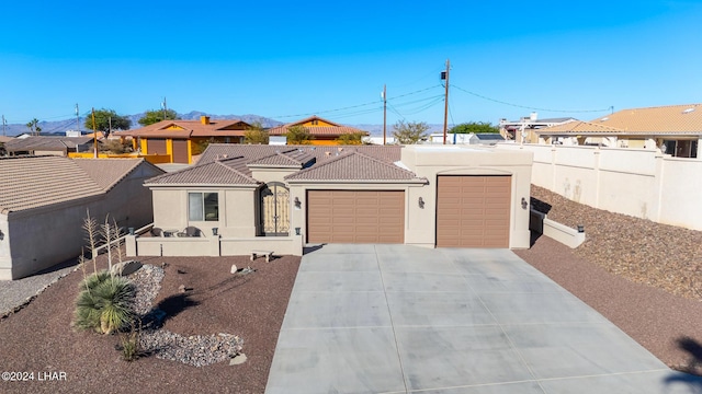 2555 Avalon Ln, Lake Havasu City, AZ 86404 - view of front of home featuring driveway, a garage, fence, and stucco siding