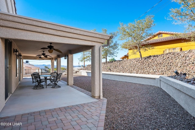 2555 Avalon Ln, Lake Havasu City, AZ 86404 - view of patio / terrace with ceiling fan, outdoor dining space, and fence