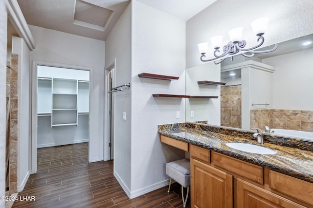 2555 Avalon Ln, Lake Havasu City, AZ 86404 - bathroom featuring wood finished floors, baseboards, a spacious closet, and vanity