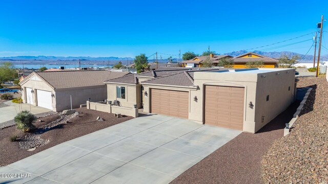 2555 Avalon Ln, Lake Havasu City, AZ 86404 - view of front of property featuring a mountain view, stucco siding, a tile roof, and a garage