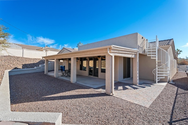 2555 Avalon Ln, Lake Havasu City, AZ 86404 - rear view of house with stucco siding, a patio, stairway, and fence