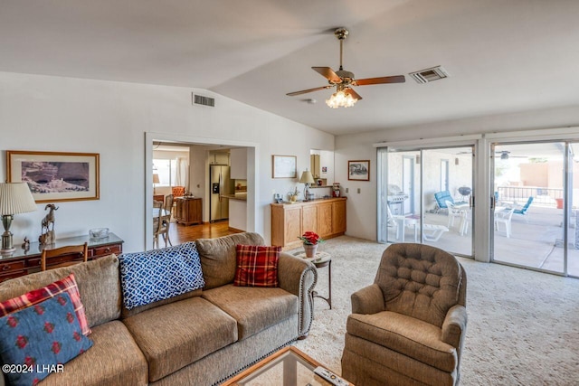 living room featuring lofted ceiling, light carpet, and ceiling fan