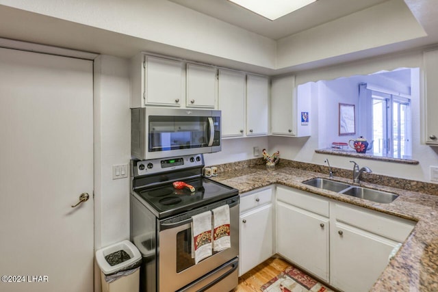 kitchen with white cabinetry, sink, and appliances with stainless steel finishes