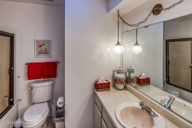 full bathroom with bath / shower combo with glass door, vanity, and toilet