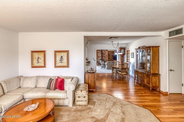 living room with hardwood / wood-style floors and a textured ceiling