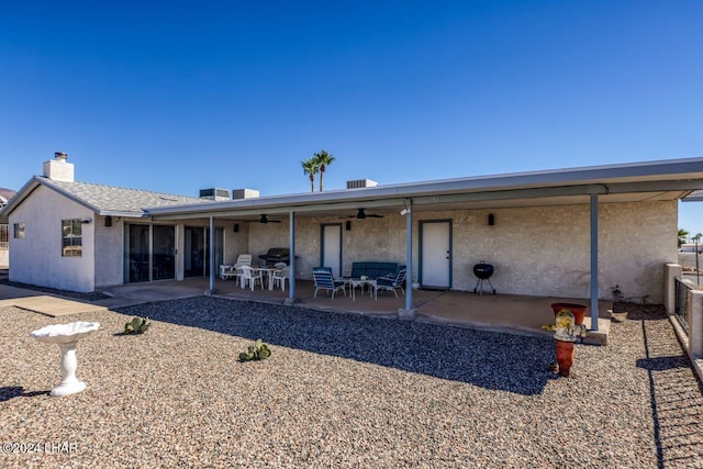 back of house with ceiling fan and a patio area