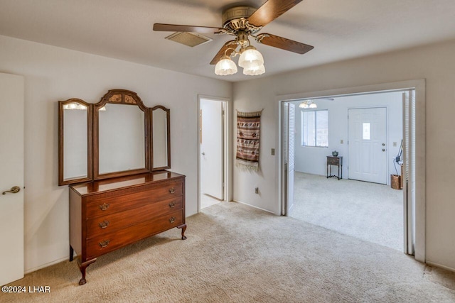 bedroom with ceiling fan and light carpet