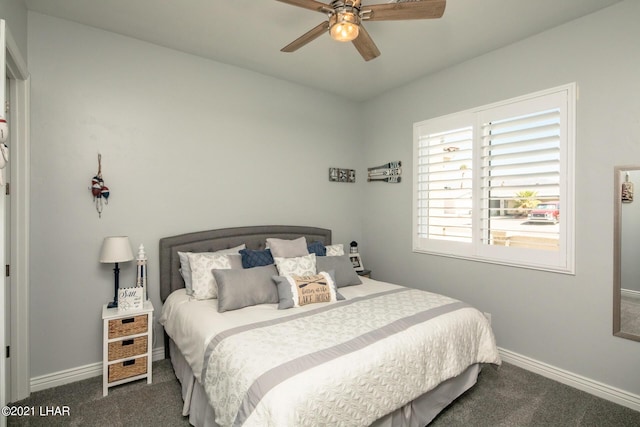 bedroom featuring ceiling fan and dark carpet