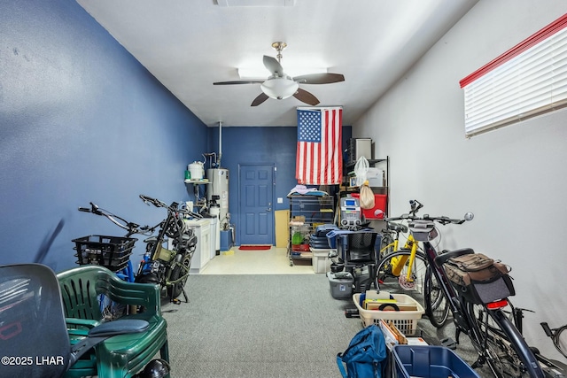 interior space with ceiling fan and water heater