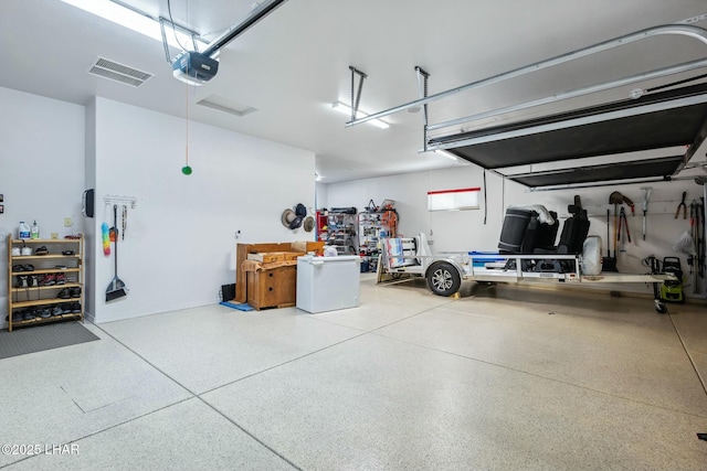 garage featuring visible vents and a garage door opener