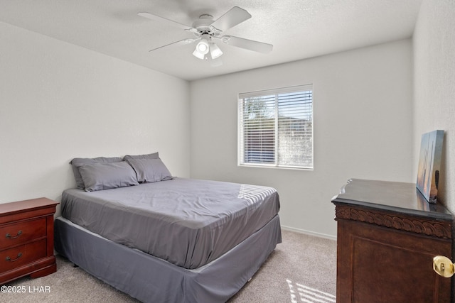 bedroom featuring baseboards, a ceiling fan, and light colored carpet