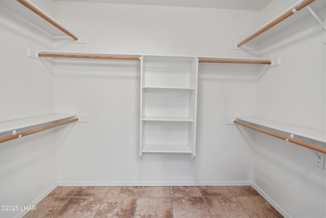 walk in closet with tile patterned floors