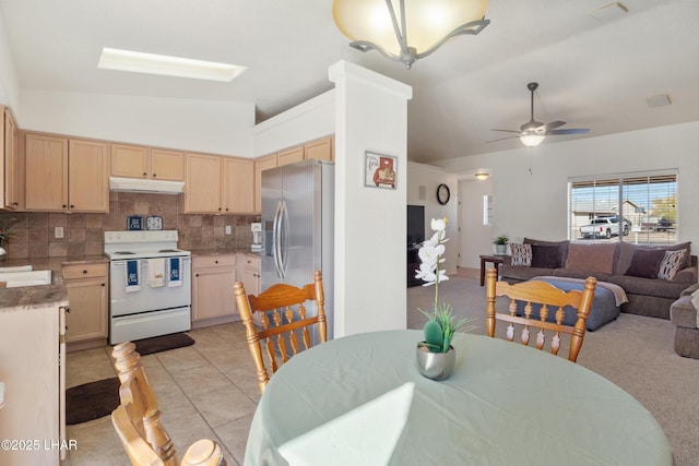 dining area featuring lofted ceiling, visible vents, ceiling fan, and light tile patterned floors