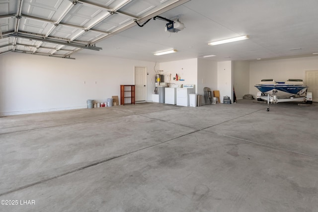 garage featuring a garage door opener and washer and dryer