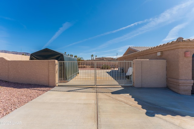 view of gate with fence