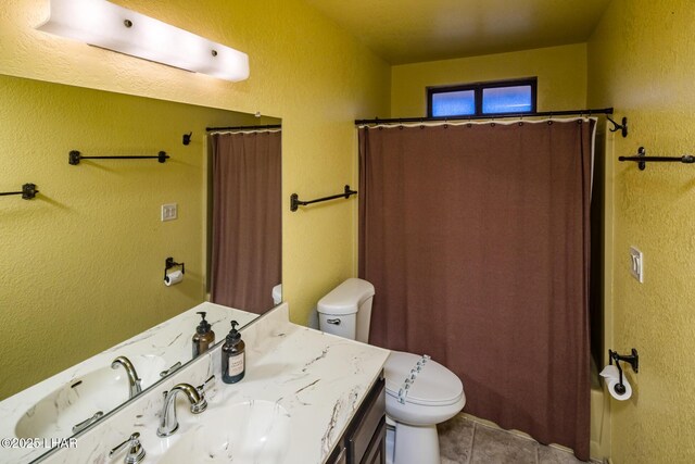 full bathroom with vanity, shower / tub combo, tile patterned floors, and toilet