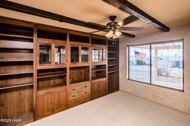 interior space with ceiling fan and beam ceiling