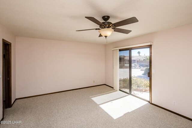 carpeted spare room featuring ceiling fan