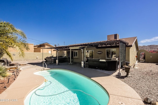 view of swimming pool featuring a jacuzzi, a fenced backyard, a fenced in pool, and a patio