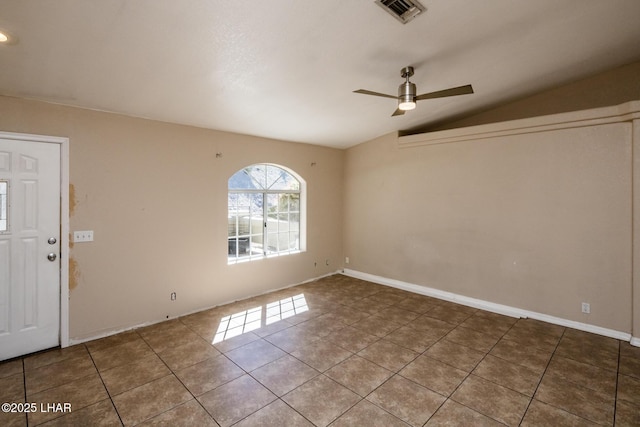 interior space with vaulted ceiling, visible vents, a ceiling fan, and tile patterned floors