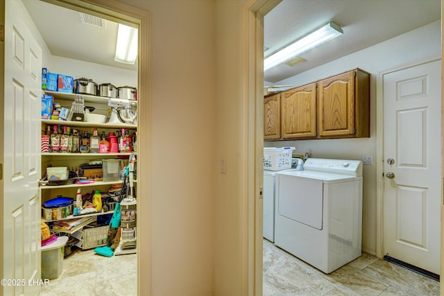 laundry room with cabinets and washing machine and clothes dryer