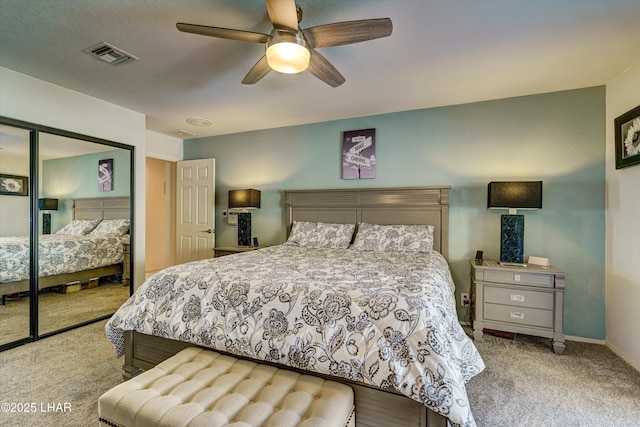 bedroom featuring ceiling fan, a closet, and carpet