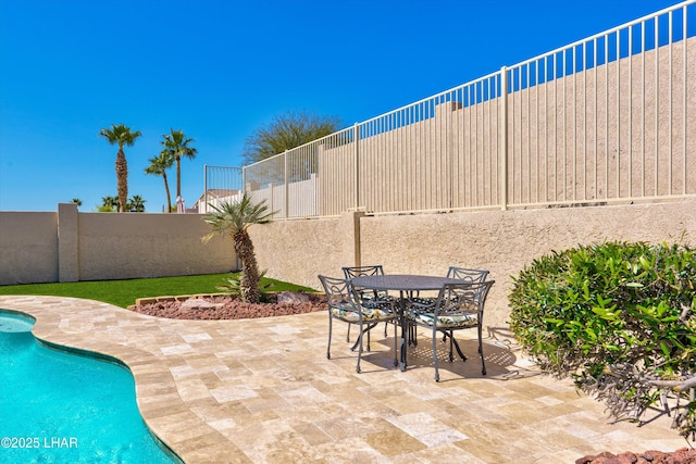 view of patio / terrace with a fenced in pool