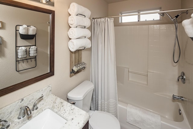 full bathroom with shower / tub combo with curtain, vanity, and toilet