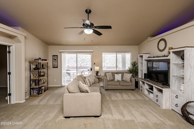 carpeted living room featuring vaulted ceiling and ceiling fan