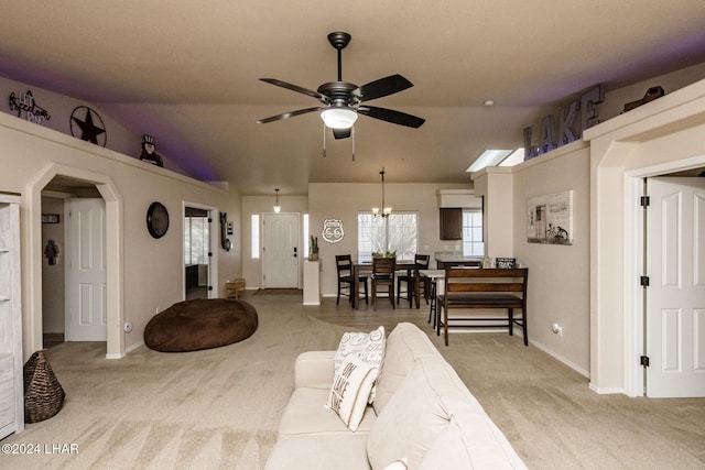 carpeted living room featuring vaulted ceiling and ceiling fan