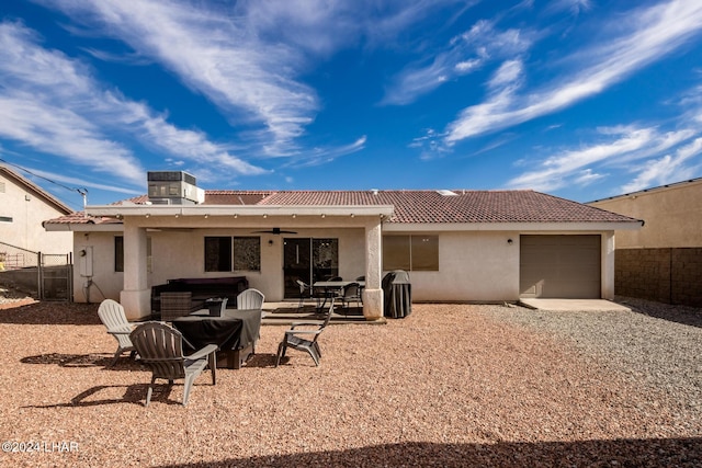 rear view of house with a hot tub, a patio, ceiling fan, and central air condition unit