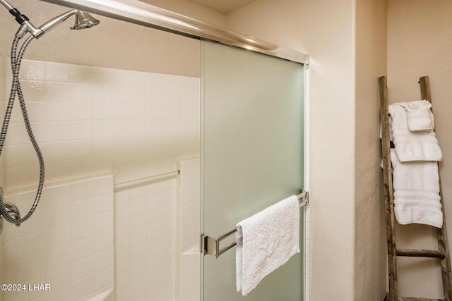 bathroom featuring a shower with door