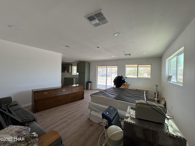 31567 94th St, Parker, AZ 85344 - bedroom with wood finished floors, multiple windows, baseboards, access to outside, and recessed lighting