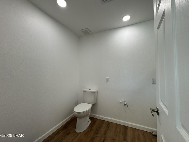 31567 94th St, Parker, AZ 85344 - bathroom with wood finished floors, toilet, baseboards, and recessed lighting