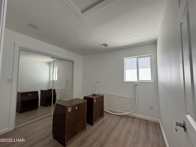 31567 94th St, Parker, AZ 85344 - unfurnished office with wood finished floors, plenty of natural light, and baseboards