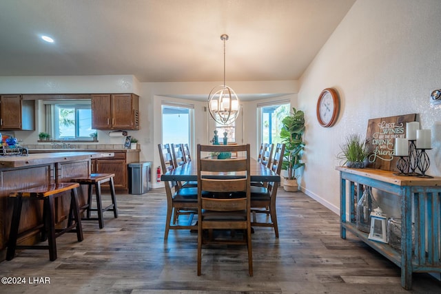 dining space with dark hardwood / wood-style floors and a chandelier