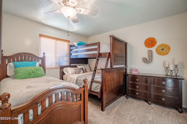 bedroom with ceiling fan and light carpet