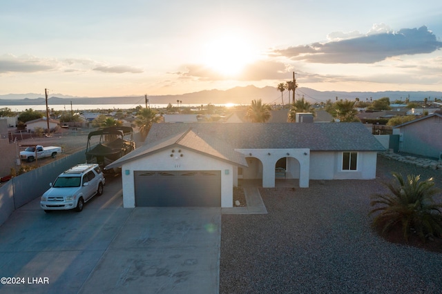 view of front facade featuring a garage and a mountain view