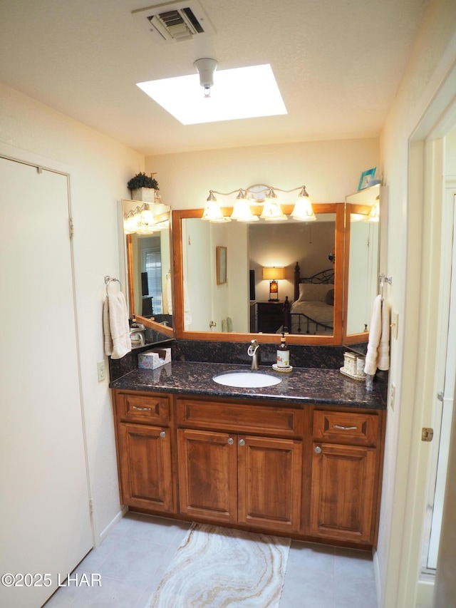1650 S Smoketree Ave Unit 168, Lake Havasu City, AZ 86403 - bathroom featuring a skylight, vanity, and tile patterned floors