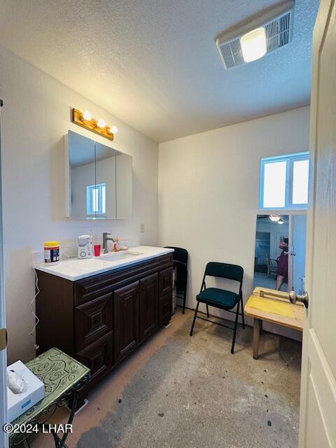 bathroom with vanity and a textured ceiling