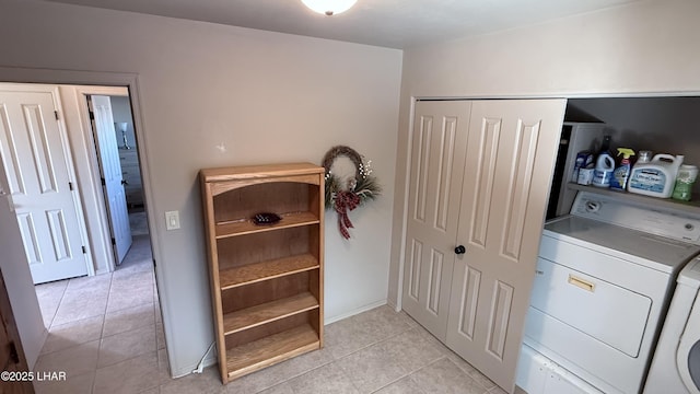 clothes washing area with laundry area, light tile patterned floors, and separate washer and dryer