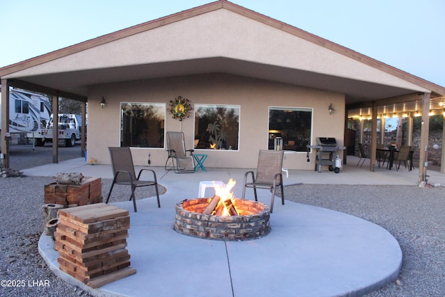 view of patio / terrace with an outdoor fire pit and grilling area