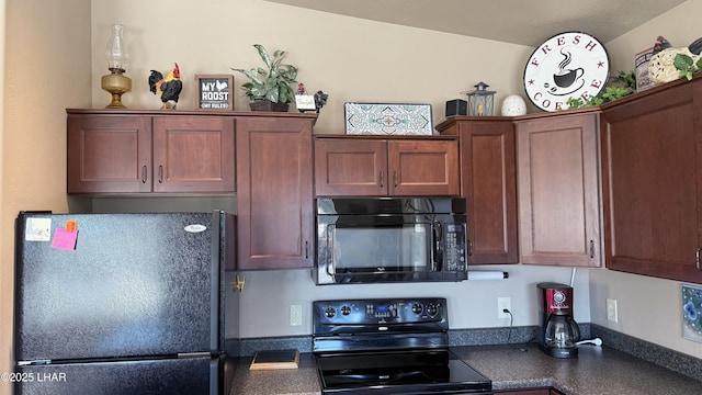 kitchen featuring dark countertops and black appliances