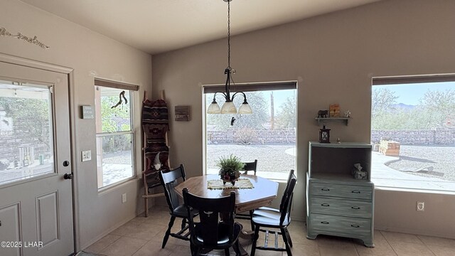 dining space with lofted ceiling and light tile patterned floors