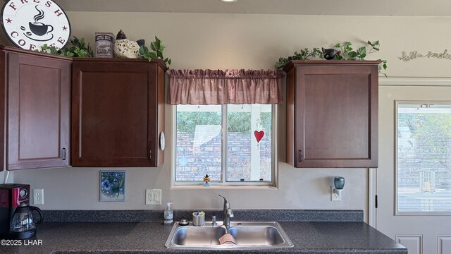 kitchen featuring dark countertops and a sink