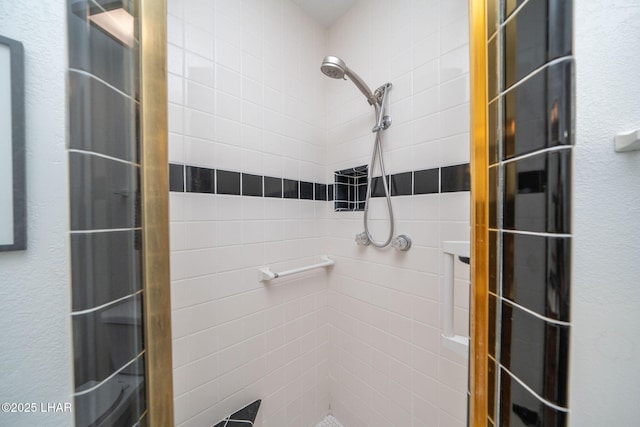 bathroom with a tile shower