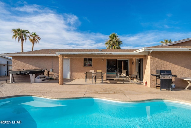 view of swimming pool featuring grilling area, a patio area, and a hot tub