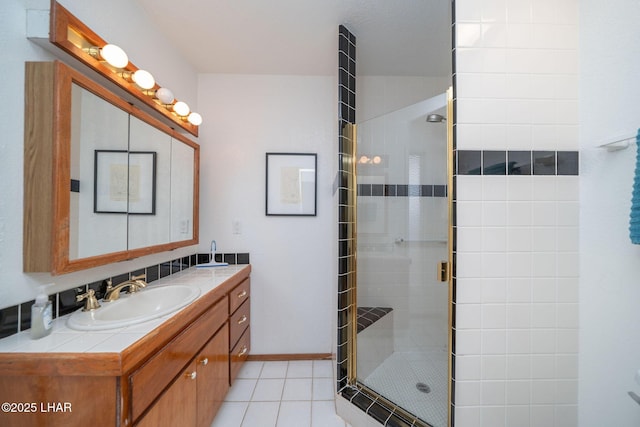 bathroom with tile patterned floors, an enclosed shower, and vanity