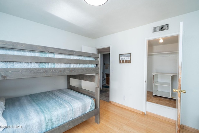 bedroom featuring hardwood / wood-style flooring and a spacious closet